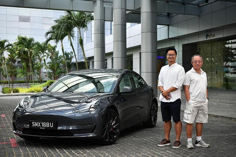 Lawyer Teng Po Yew and his father, retiree James Teng, with the new Tesla Model 3 at SPH News Centre yesterday. The younger Mr Teng was the first customer to collect his new Tesla car.