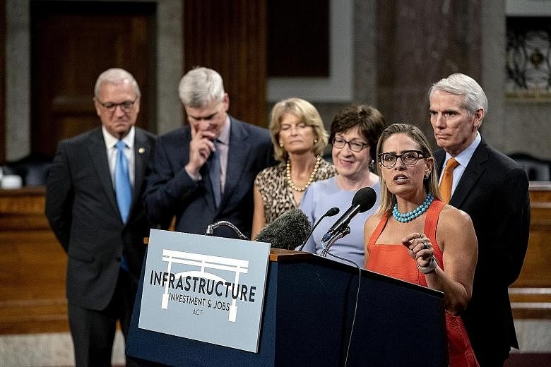 Senator Kyrsten Sinema, a Democrat from Arizona, speaking at a news conference in Washington on Wednesday. The vote was a victory for President Joe Biden, who has long promised to break through the partisan gridlock gripping Congress and accomplish b