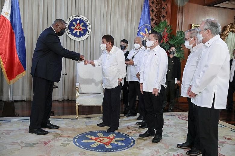 US Defence Secretary Lloyd Austin (left) greeting Philippine President Rodrigo Duterte with a fist bump at the Malacanang Palace in Manila on Thursday. The Visiting Forces Agreement between the two countries provides rules for the rotation of thousan
