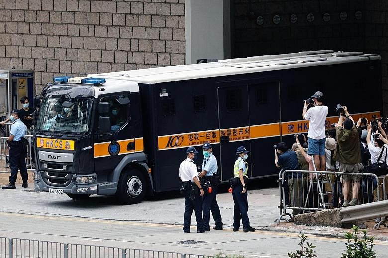 A prison van carrying Tong Ying-kit (above) leaving the High Court in Hong Kong yesterday after the 24-year-old's sentencing. He was accused of driving his motorcycle into three riot police officers during a protest last year while carrying a flag wi