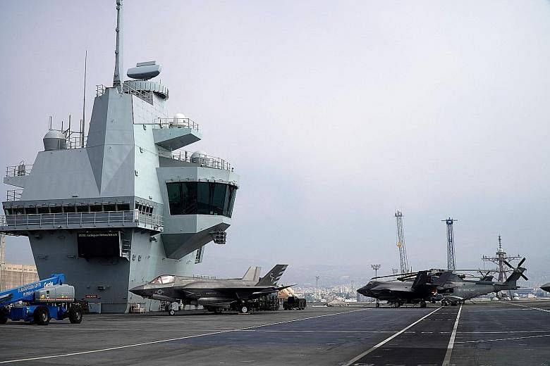 Aircraft on the deck of the Royal Navy's HMS Queen Elizabeth aircraft carrier, moored in Limassol, Cyprus, on July 1. The British government said its carrier strike group is lawfully navigating the South China Sea.