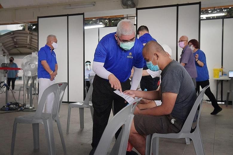A mobile vaccination team at 22A Whampoa Precinct Hall yesterday. Since July 7, mobile vaccination teams alone have reached out to about 3,240 individuals, said the Ministry of Health in an update yesterday. ST PHOTO: ALPHONSUS CHERN