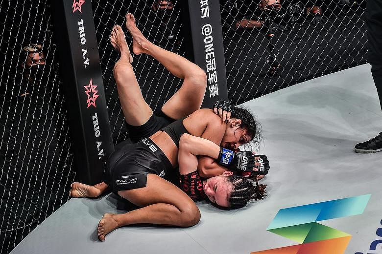 Indian mixed martial arts fighter Ritu Phogat pinning down China's Lin Heqin in their atomweight bout at the One: Battleground event on Friday night. The "Indian Tigress", who had lost her previous fight in May, got back to winning ways by claiming a