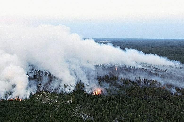 The forest fire raging in Kalajoki, north-western Finland, on Monday. An exceptionally long heatwave saw the country experiencing record temperatures this summer, with June averaging 20 deg C, some four to five degrees above historical averages. PHOT