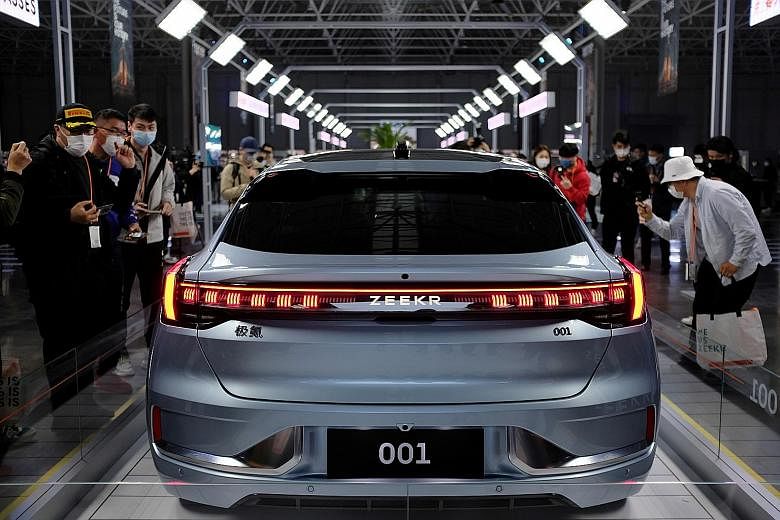 Visitors checking out the 001, a model from Geely's new premium electric vehicle (EV) brand Zeekr, at its factory in Ningbo, in China's Zhejiang province, in April. Domestic EV sales in the four biggest auto markets in Asia - China, Japan, India and 