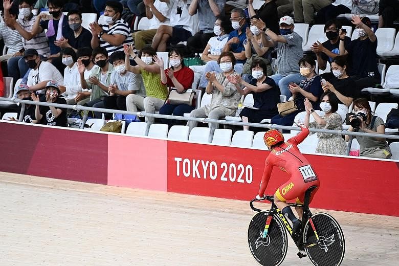 China's Zhong Tianshi celebrating her win in front of some 1,800 fans at the Izu Velodrome.