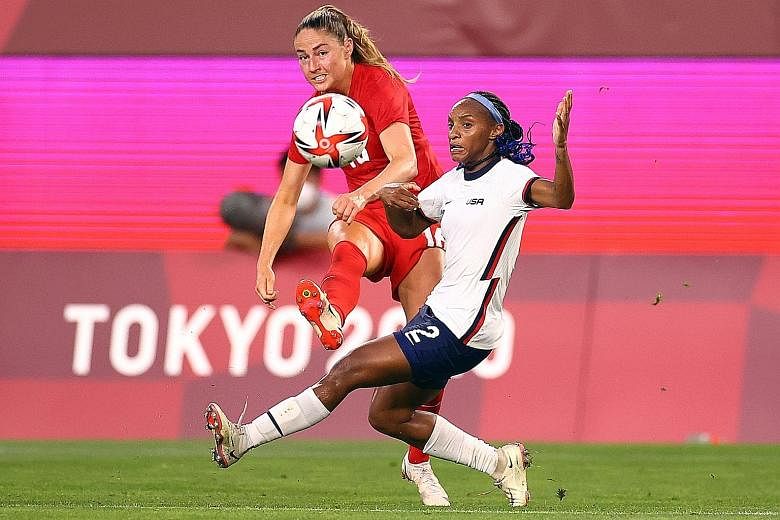 Canada's Janine Beckie and American Crystal Dunn vying for the ball yesterday. Canada beat the US 1-0 via a penalty in the 75th minute. It was just their fourth win over the Americans in 62 meetings.