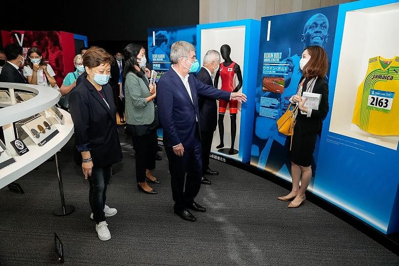 Olympic Foundation for Culture and Heritage director Angelita Teo (above and right) accompanying IOC president Thomas Bach (centre) on his visit to the Olympic Agora exhibition