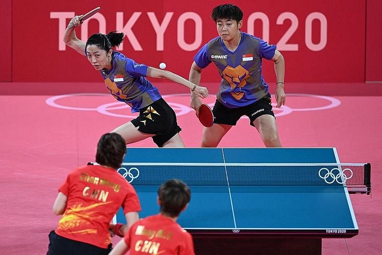 Singapore's Yu Mengyu (left) and Lin Ye losing the first match of their quarter-final tie against China yesterday.
