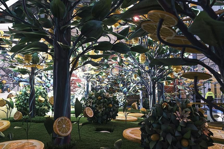 Citrovia, an art installation of fake lemon trees and slices, at a New York construction site. Construction sheds are a necessary evil, meant to protect workers and passers-by, but recent efforts have reimagined them as "experiential installations". 