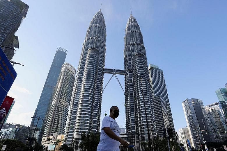 The Petronas Twin Towers in Kuala Lumpur, amid a Covid-19 lockdown in June. OCBC Bank's non-performing loans in Malaysia rose 17 per cent year on year to $959 million in the second quarter.
