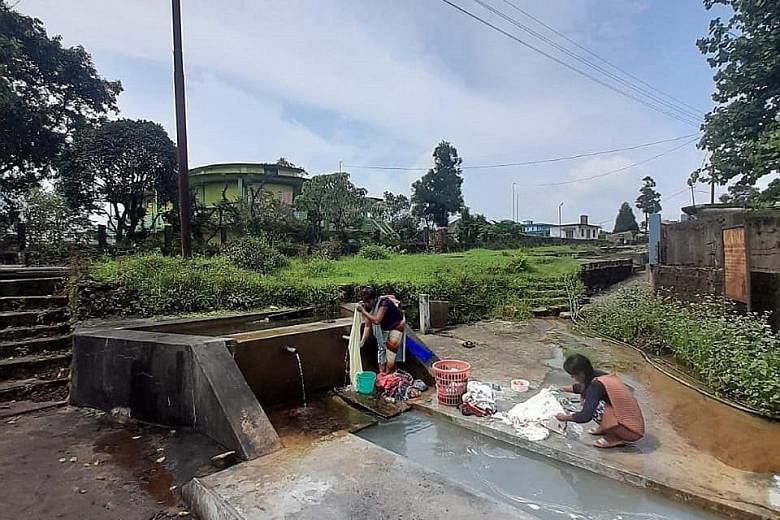 Locals in Mawmluh village washing clothes. They rely on streams and a canal that channels water from a nearby river.