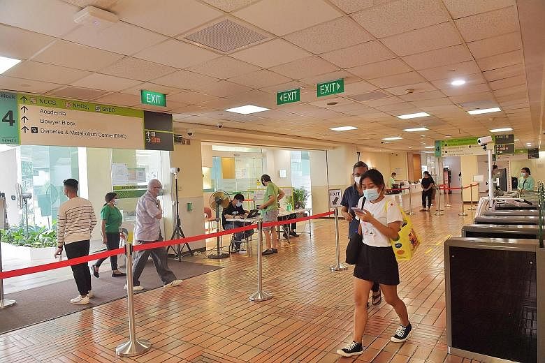 At Singapore General Hospital yesterday, The Straits Times observed that there were only a few people at the ward registration counters. ST PHOTO: ALPHONSUS CHERN