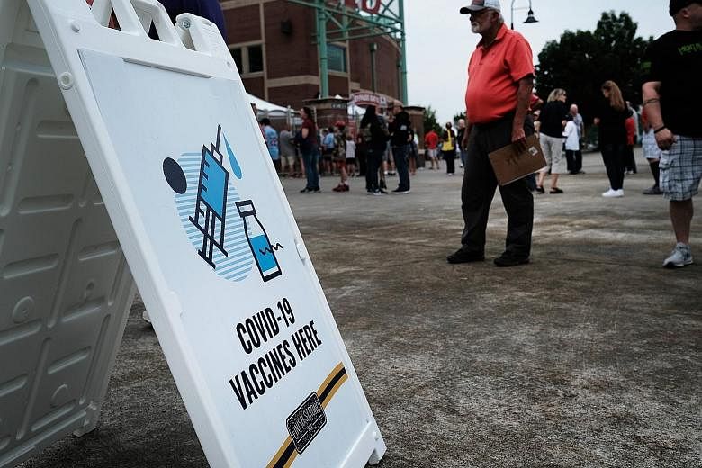 People at a Covid-19 vaccination drive held at a baseball stadium in Springfield, Missouri, on Thursday. As companies in the US move to reopen their offices, vaccination rates in the country have stalled at around 50 per cent and infections have surg