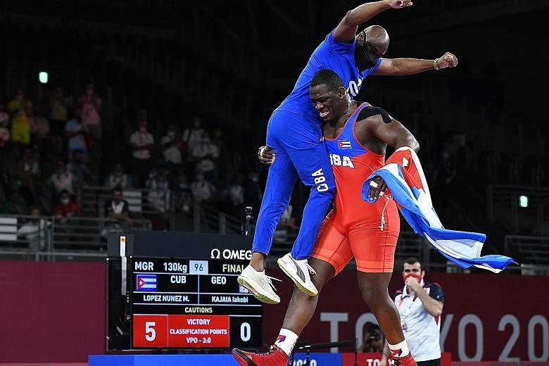 Mijain Lopez of Cuba celebrating his fourth wrestling gold in the 130kg class. After five years of waiting, athletes cut loose when the Games began.