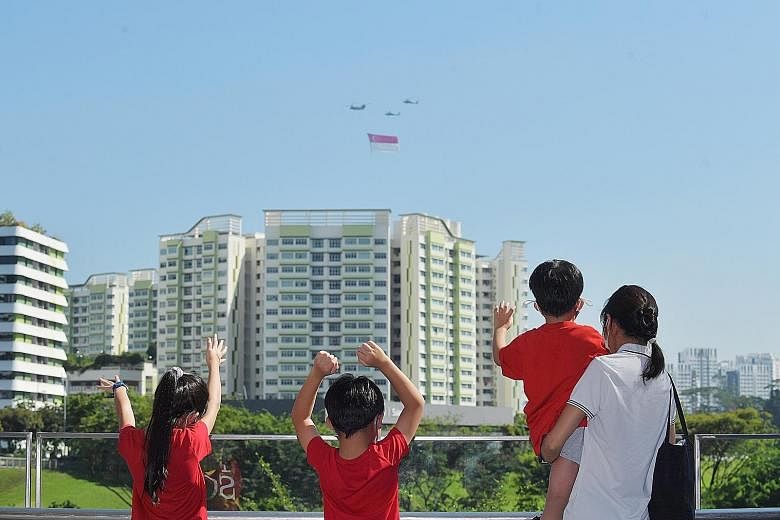 Chinook helicopters, each escorted by a pair of Apache helicopters, flying by in the south of Singapore yesterday. They were carrying the state flag for heartland fly-pasts covering the eastern and western parts of the island. The F-15SG jets soaring