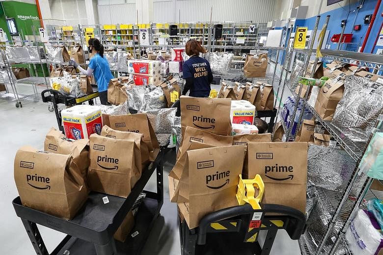 Workers at the Amazon Fresh Fulfilment Centre. Groceries from Amazon Fresh, digital goods and services such as in-app purchases on Amazon service Twitch, as well as subscription schemes such as Amazon Prime will not be affected by the surcharge. When