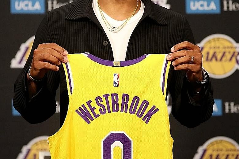 Los Angeles Lakers' Russell Westbrook with his jersey during a press conference at Staples Centre on Tuesday. The star guard will link up with LeBron James and Anthony Davis in their bid for an 18th NBA title.