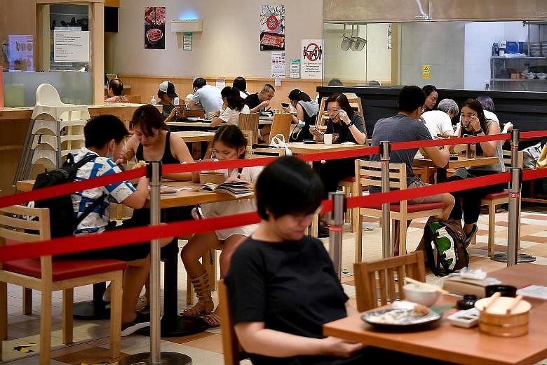 Diners at a restaurant in Takashimaya Shopping Centre on Aug 10. Asked under what circumstances Singapore would tighten restrictions again, Trade and Industry Minister Gan Kim Yong said it depends on factors such as the number of severe Covid-19 case