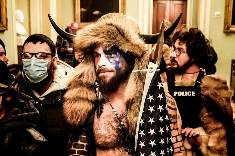 Capitol rioter 'QAnon Shaman' pleads guilty, disappointed Trump didn't ...