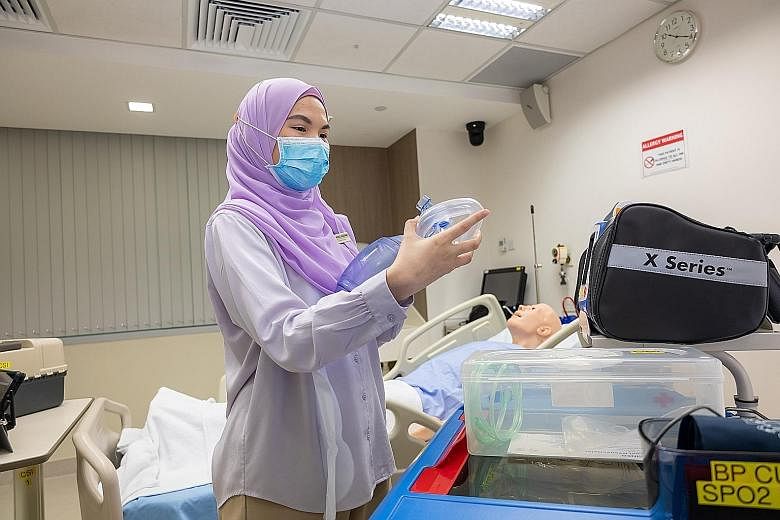 Ms Nurul Hadainah Muhamad Suhaimi checking a device intended for use in simulation training.