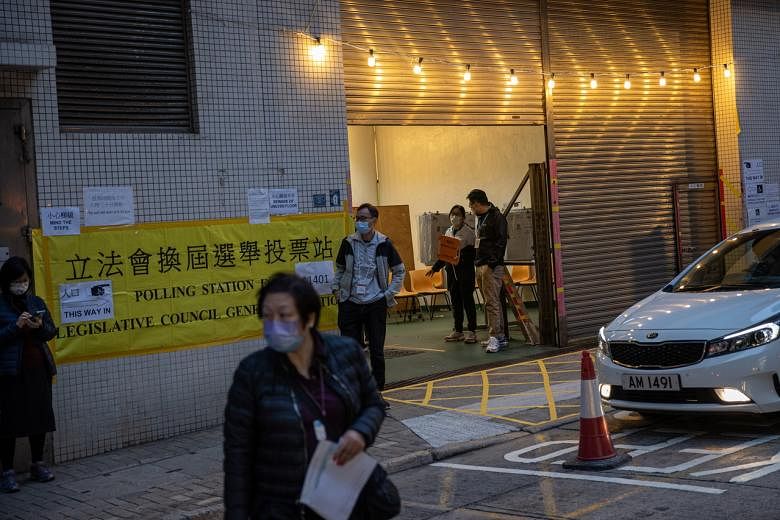 <p>epa09649340 A woman walks out of a polling station in Hong Kong, China, 19 December 2021. After a postponement of more than a year, this is the first election for the Legislative Council after Beijing’s overhaul of Hong Kong’s electoral system to e