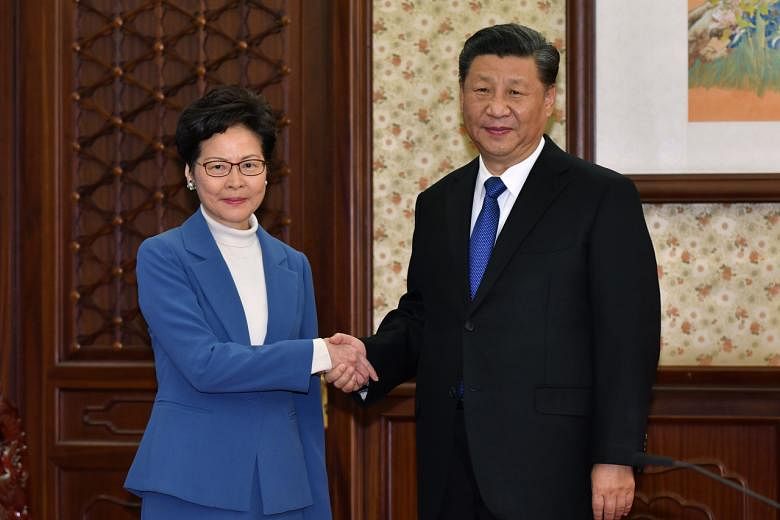 <p>In this photo provided by Hong Kong Government Information ServicesChinese President Xi Jinping, right, shakes hands with Hong Kong Chief Executive Carrie Lam in Beijing, China, Monday, Dec. 16, 2019. Chinese President Xi Jinping has said Hong Kong has