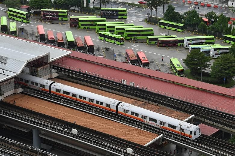 Generic photo of MRT trains on the tracks near Jurong East MRT Station and buses at the bus interchange taken on August 1, 2020Can be used for bus, trains, public transport, fare hike, LTA, land transport authority stories.