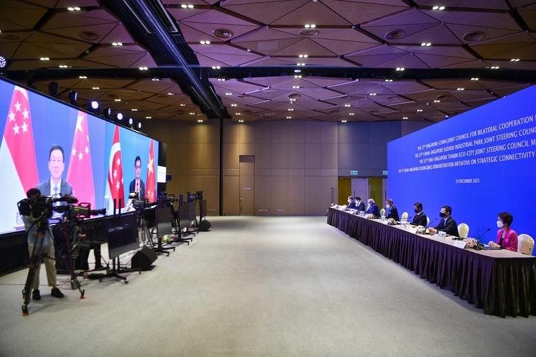 (From left) Dr Tan See Leng, Lawrence Wong, S Iswaran, Dr Vivian Balakrishnan, Chan Chun Sing, Desmond Lee and Low Yen Ling at the 17TH JOINT COUNCIL FOR BILATERAL COOPERATION AND RELATED JOINT STEERING COUNCIL MEETINGS and on screen is Han Zheng, Vice-Pr