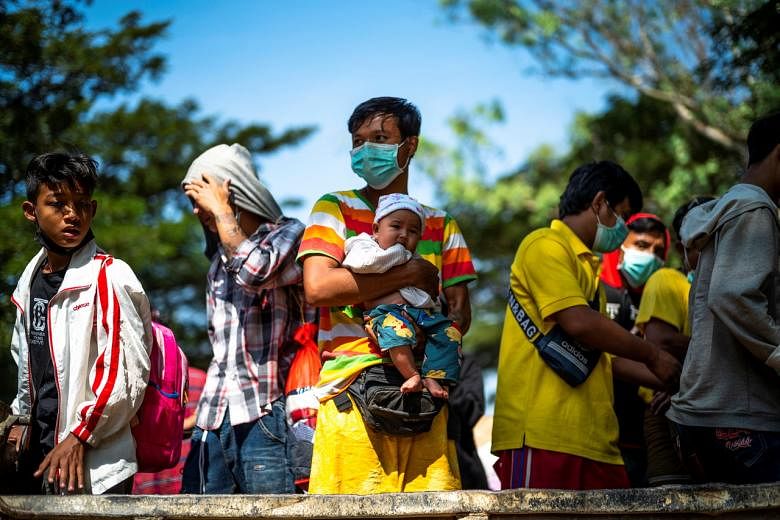 <p>Refugees, who fled a flare-up in fighting between the Myanmar army and ethnic minority rebels prepare, as they are voluntarily returning across the border to Myanmar, at a pier in Mae Sot district, Tak province, Thailand, December 19, 2021. REUTERS/Ath