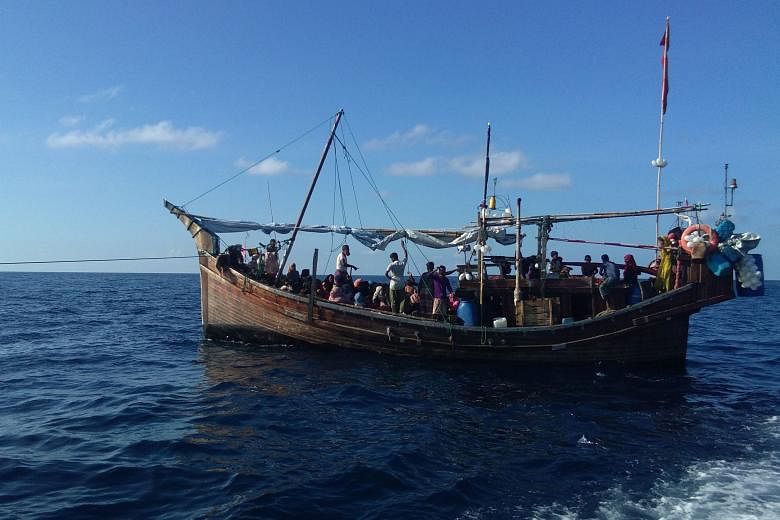<p>This photo taken on December 27, 2021 shows a wooden boat transporting Rohingya refugees after it was intercepted in the waters off Bireuen, Aceh province and were denied refuge in Indonesia. (Photo by AFP)</p>
