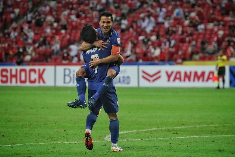 <p>Thailand’s Chanathip Songkrasin celebrating with teammate Supachok Sarachat after scoring his second goal against Indonesia during the first-leg of the AFF Suzuki Cup final at the National Stadium on Dec 29, 2021. </p>