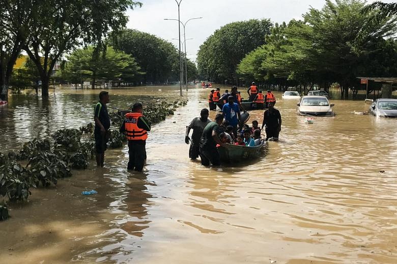 Recent flooding complicates Malaysia's economic recovery | The Straits ...