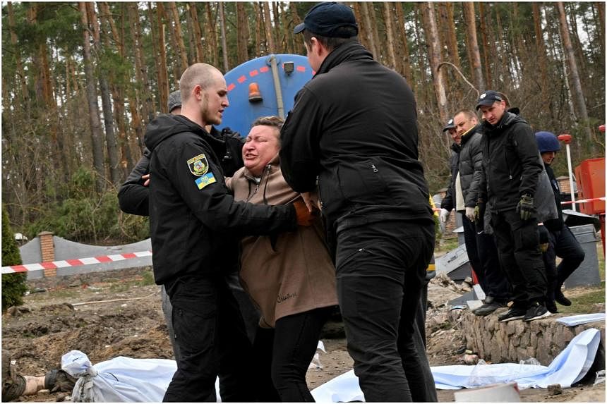 Ukrainian Mother Weeps By Roadside Grave After Finding Corpse Of Son