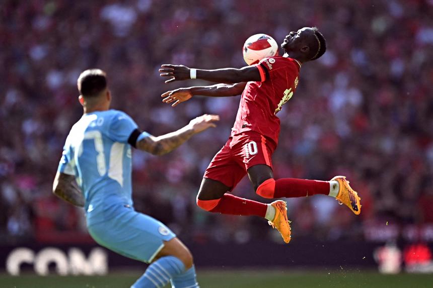 Football Liverpool keep quadruple dream alive by beating Man City to