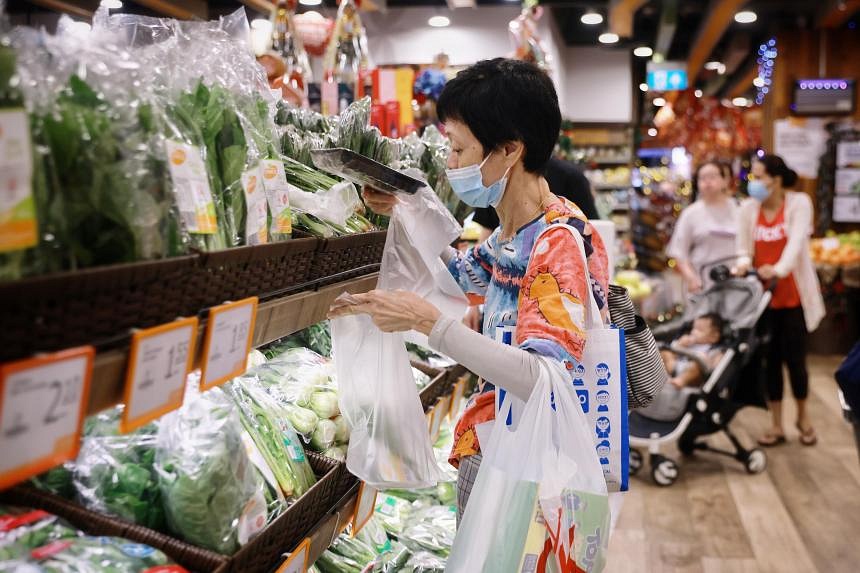 Malaysian Grocery Shoppers in a shopping frenzy at a Vegetable