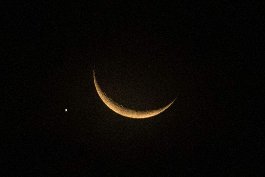 Planet of love Venus sidles up to glowing crescent moon in Singapore ...