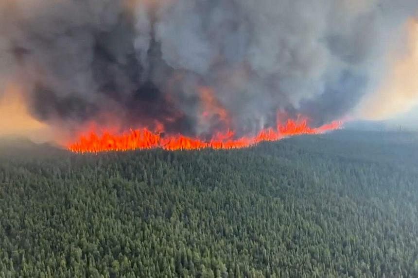 Wildfires spread in British Columbia, Quebec sees signs of progress