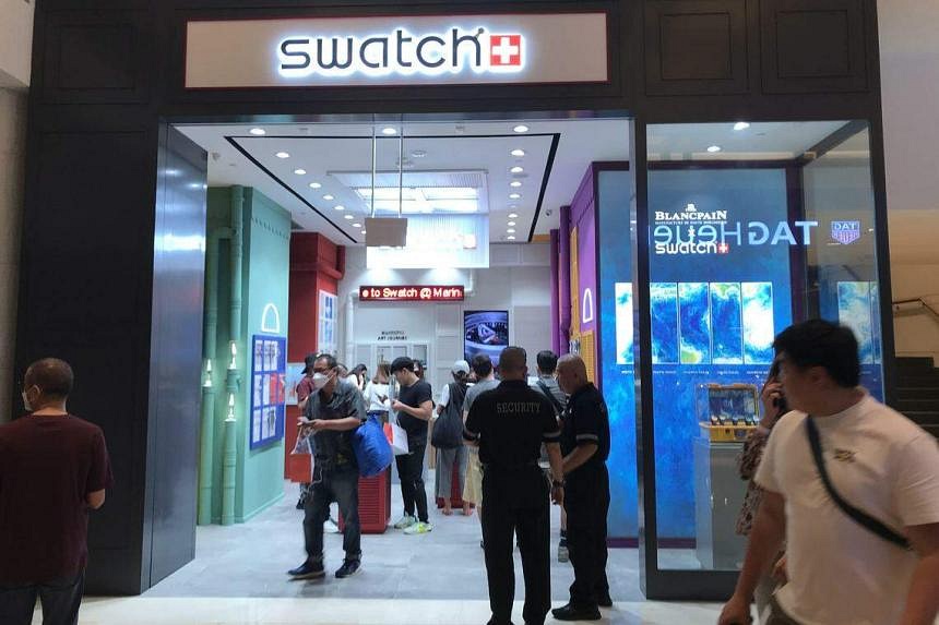 Private security maintain order in queues at new Swatch x