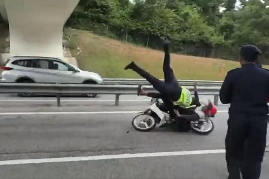 Malaysian police arrest motorcyclist who rammed road transport officer at roadblock