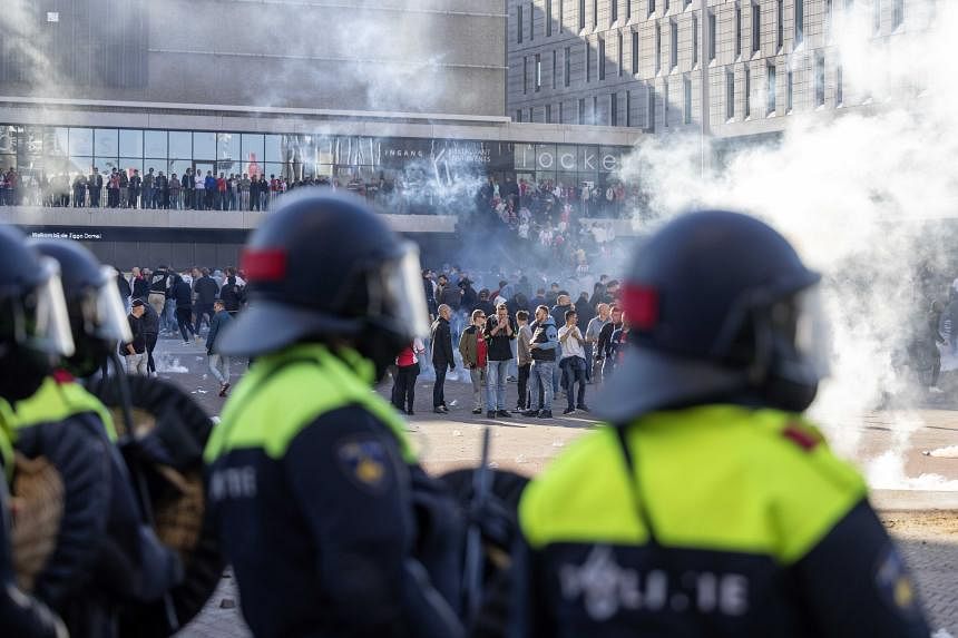 Ajax vs Feyenoord: Police use tear gas to disperse fans outside stadium  after match abandoned