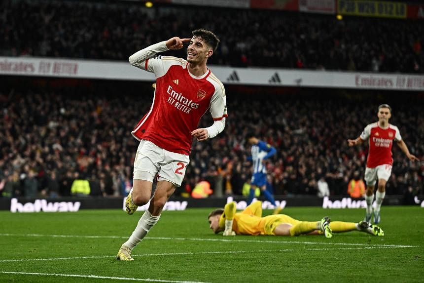Soccer-Arsenal move top of the league with 2-0 win over Brighton