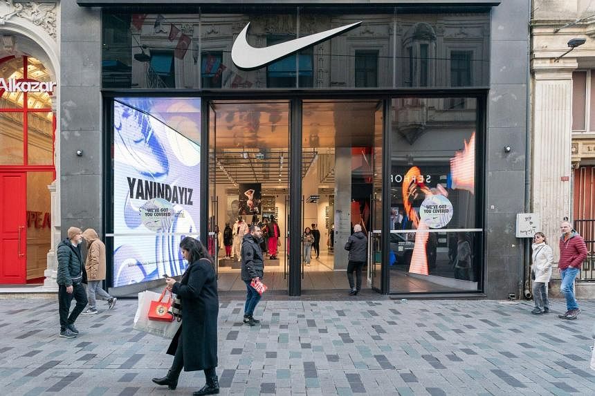 Nike shares tumble after company cuts sales forecast on choppy demand ...