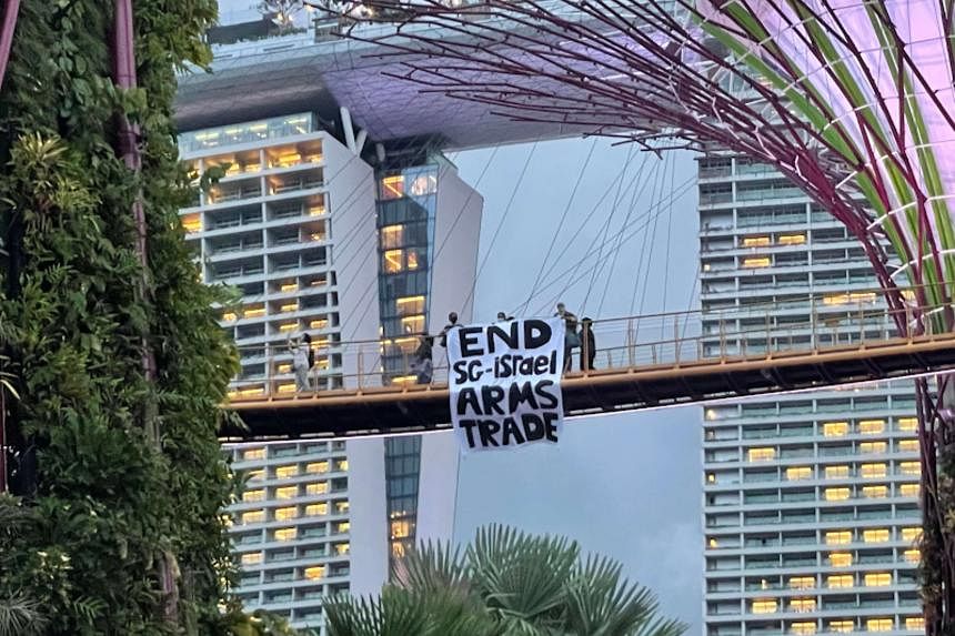 3 people with protest banner at Gardens by the Bay under probe