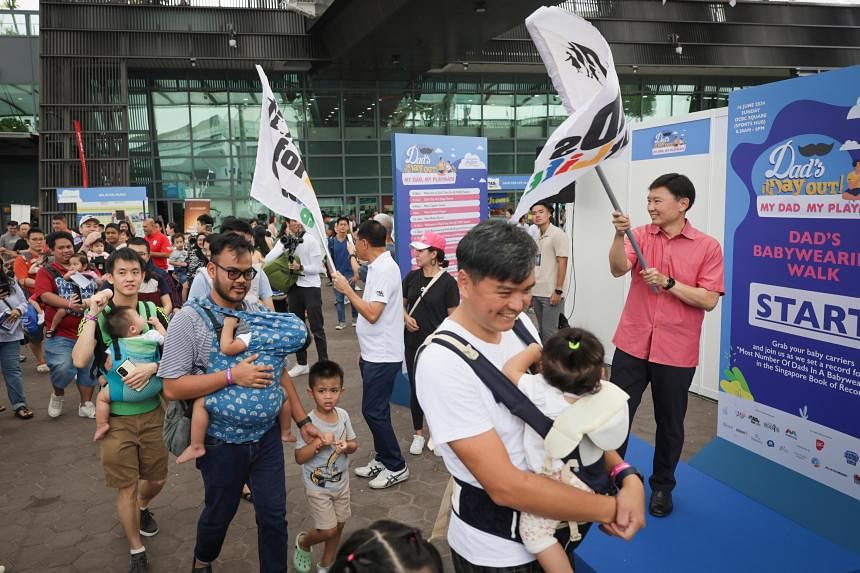 Baby-wearing dads celebrate Fathers’ Day with record-breaking walk in S’pore