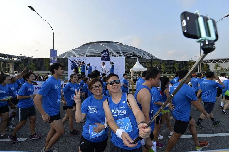 Participants taking a selfie at The Straits Times Run at the Hub last September. This year, runners can choose to sign up for a 5km fun run, a 10km competitive run or an 18.45km celebratory route to mark ST's 170th anniversary. All runners will get t