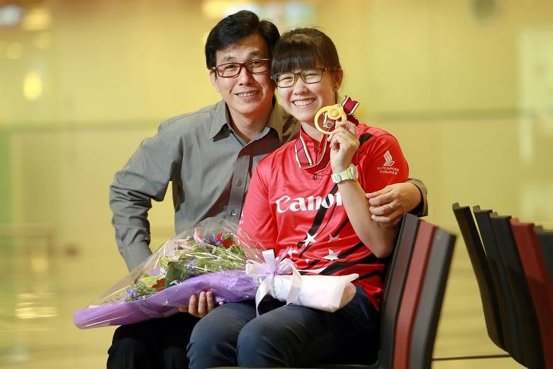 Inaugural Bowling World Open champion Joey Yeo is received by her proud dad Jeffrey, 49, at the airport.
