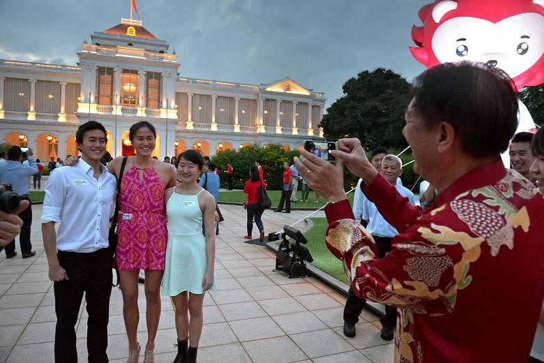 (Clockwise from above): At the Istana Garden Party, taking a wefie with Prime Minister Lee Hsien Loong; Deputy Prime Minister Teo Chee Hean snapping the Quah siblings; and Minister Lawrence Wong performing on the guitar.