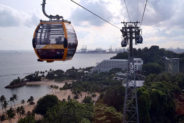 Passengers get a view of Sentosa from up high in one of the 51 cable-car cabins on the new Sentosa Line. The new intra-island travel option, costing over $78 million, was officially launched yesterday. The 890m-long link transports visitors on the is