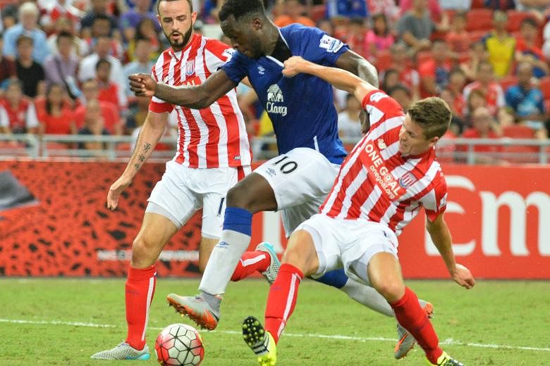 Everton's Romelu Lukaku (centre) being challenged by Stoke's Marc Wilson (left) and Marco van Ginkel during their Barclays Asia Trophy opener. Stoke manager Mark Hughes praised his team for their "accomplished performance", saying that "collectively 